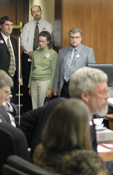 State Public Defender John Stuart, front right, is among those testifying against Emilys Law during the March 13 hearing of the House Public Safety and Civil Justice Committee. Watching are Travis and Lynn Johnson, center, along with Rep. Torrey Westrom, left, and Rep. Bud Nornes, right, the sponsor of HF699, which would change the age of adult certification for juvenile violence from 14 to 13. The Johnsons 2-year-old daughter, Emily Lynn, died of a severe head injury one day after an assault by a 13-year-old boy at her Fergus Falls day care.