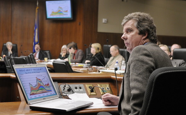David Hughes, a geologist with the Geological Survey of Canada, checks the overhead display while giving a Power-Point presentation on peak oil production and other energy sources during at a March 17 hearing of the House Energy Finance and Policy Division.