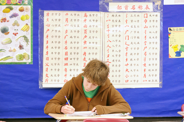 Will Robertson, a sophomore at Highland Park Senior High in St. Paul, works on a worksheet during the Chinese III class. (Photo by Tom Olmscheid)