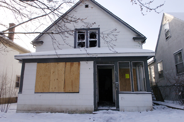 Like this home in Northeast Minneapolis, houses in foreclosure are subject to vandalism and contribute to the deterioration of neighborhoods. (Photo by Tom Olmscheid)