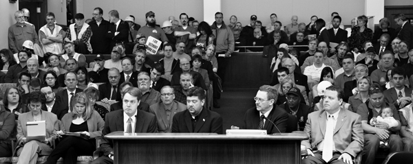 During the April 22 House Taxes Committee meeting, Rep. Mike Nelson, second from right, House sponsor of a proposal to finance a Mall of America expansion, listens to, from left, Kyle Makarios, political director for the North Central States Regional Council of Carpenters, David Ybarra, business manager for the Minneapolis Building & Construction Trades Council, and Rhys Ledger, strategic campaigns director at Teamsters Local 120. There were more than five hours of testimony about the proposal. (Photo by Tom Olmscheid)