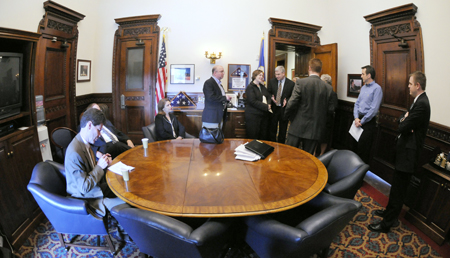 House and Senate leadership meet in the conference room just off Gov. Tim Pawlenty�s office prior to a May 18 news conference to announce a budget deal. This is the room where legislative leaders and Pawlenty spent most of the end of the 2008 legislative session working out the budget agreement. In attendance, from left, Senate Majority Leader Larry Pogemiller, Senate Minority Leader David Senjem, Senate Assistant Majority Leader Tarryl Clark, Finance Commissioner Tom Hanson, House Speaker Margaret Anderson Kelliher, Rep. Tom Emmer, Pawlenty�s Press Secretary Brian McClung, Pawlenty and House Majority Leader Tony Sertich. (Photo by Tom Olmscheid)