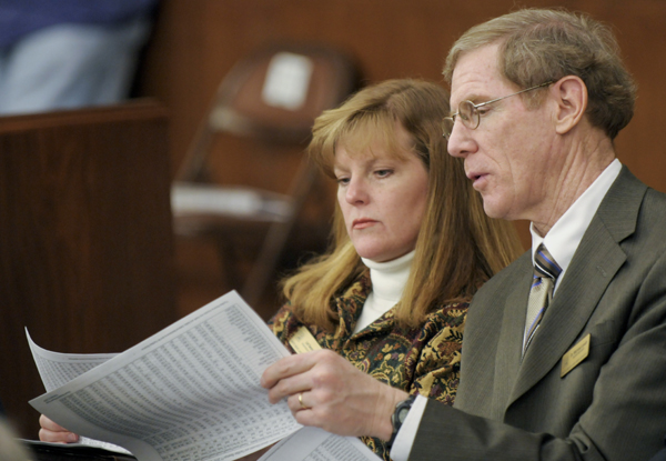 Superintendent Michael Lovett, right, and Board Member Lori Swenson from the White Bear Lake Public Schools examine runs of potential funding levels for school districts as part of a proposed new education funding framework. They attended the Feb. 10 meeting of House K-12 Education Finance Division, where the “New Minnesota Miracle” was presented. (Photo by Tom Olmscheid)