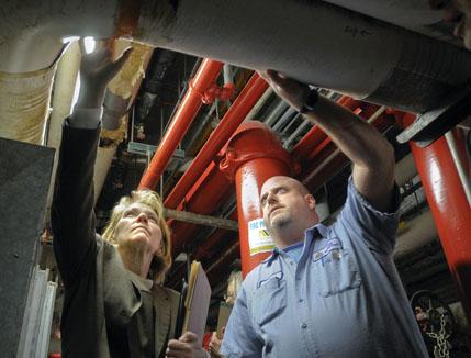 Capitol Plant Management Engineer Dave Albien and Rep. Mary Kiffmeyer examine an aging heating system during a March 3 tour of Capitol building deficiencies by the House State Government Finance Division. (Photo by Andrew VonBank)