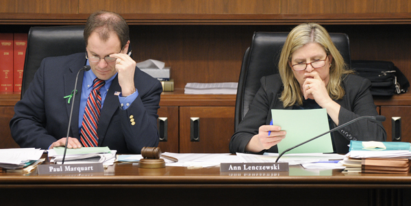 Rep. Paul Marquart, chairman of the House Property and Local Sales Tax Division, and Rep. Ann Lenczewski, chairwoman of the House Taxes 
Committee, study one of the “Green Acres” proposals that was heard March 17 during a joint hearing of the two bodies. (Photo by Tom Olmscheid)