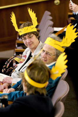 Bell Museum of Natural History Director Susan Weller, top, along with Gretchen Kreuter, center, and Lin Nelson Mayson wear moose antlers as they talk April 14 before the first meeting of the Capital Investment Finance Conference Committee. The House proposal does not include funding for a new museum, but the Senate bonding proposal does fund the project. (Photo by Tom Olmscheid)