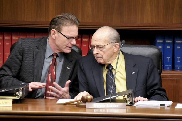 Sen. Steve Murphy, left, talks with Rep. Bernie Lieder prior to the May 1 Transportation Finance Conference Committee meeting. (Photo by Tom Olmscheid)