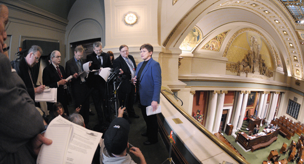 Rep. Alice Hausman, right, releases the $999.8 million House bonding proposal to media members during a Feb. 4 news conference in the House Gallery. Hausman, chairwoman of the House Capital Investment Finance Division, said the bonding bill should be ready for a floor vote Feb. 15. (Photo by Tom Olmscheid)