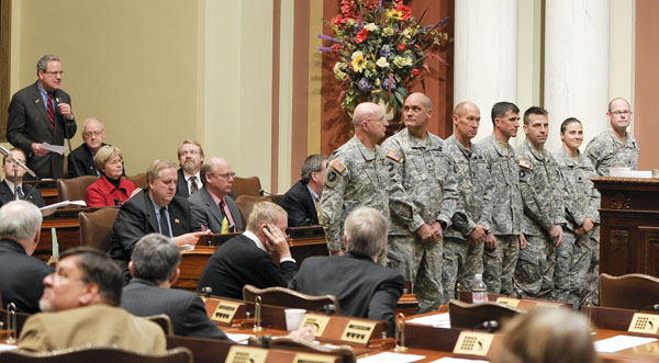 Rep. Phil Sterner, whose district includes the Rosemount National Guard Armory and Community Center, recognizes the command staff of the 34th Red Bull Infantry Division Feb. 12 on the House floor. The division is based at the Rosemount facility. Red Bulls in attendance are, from left: Maj. Gen. Richard Nash, Brig. Gen. David Elicerio, Command Sgt. Maj. Doug Julin, Col. Neal Loidolt, Col. Dirk Kloss, Lt. Col. Stefanie Horvat and Lt. Col. John Morris. (Photo by Andrew VonBank)