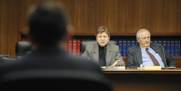 Chris DeLaForest, left, Gov. Tim Pawlenty�s director of Legislative and Cabinet Affairs, and Sen. Keith Langseth, right, listen as Rep. Alice Hausman asks a question during a Feb. 24 meeting of a working group of the Capital Investment Conference Committee. (Photo by Tom Olmscheid)