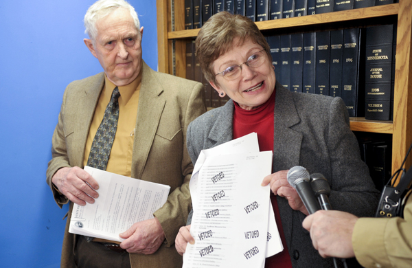 At a March 15 press conference, Rep. Alice Hausman shows a section of the capital investment law that contains several gubernatorial line-item vetoes to Minnesota State Colleges and Universities systems projects. Hausman and Sen. Keith Langseth, left, sponsor the law that received a $313 million cut by Gov. Tim Pawlenty. (Photo by Tom Olmscheid)