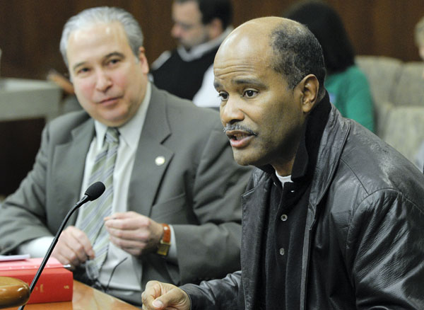 Melvin W. Carter, a retired St. Paul police officer, right, testifies March 23 before the House Public Safety Finance Division in support of a bill that would provide greater oversight and accountability for multi-jurisdictional violent crime enforcement teams. Rep. Michael Paymar, left, sponsors the bill. (Photo by Andrew VonBank)