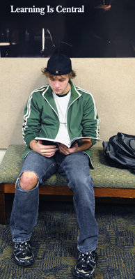 A student at Century College reads in the commons. (Photo by Tom Olmscheid)