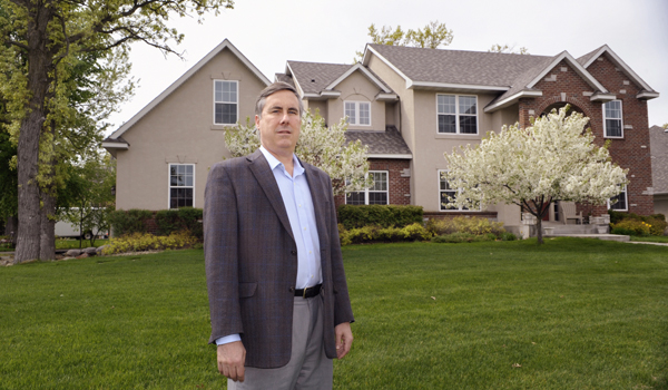 Paul Stutler stands in front of his Eagan home that suffered severe water damage. (Photo by Tom Olmscheid)