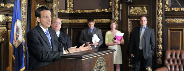 At a May 5 news conference, Gov. Tim Pawlenty reacts to the Minnesota Supreme Court’s decision in the unallotment lawsuit saying, “I strongly disagree with this 4-3 decision by the court.” Others at the press conference, include from second left, Minnesota Management & Budget Commissioner Tom Hanson, Deputy Chief of Staff Brian McClung, State Budget Director Kristin Dybdal and Deputy Revenue Commissioner James Schowalter. (Photo by Tom Olmscheid)