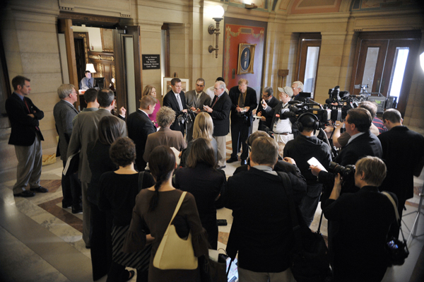 House Majority Leader Tony Sertich and Sen. Tarryl Clark are surrounded by the media after an afternoon budget meeting with the governor May 6. (Photo by Tom Olmscheid)