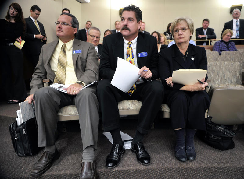 Faribault Mayor John Jasinski, from left, City Manager Tim Murray and Rep. Patti Fritz wait for their opportunity to testify before the House Finance Committee Oct. 18 about their cities flood damage. (Photo by Tom Olmscheid)