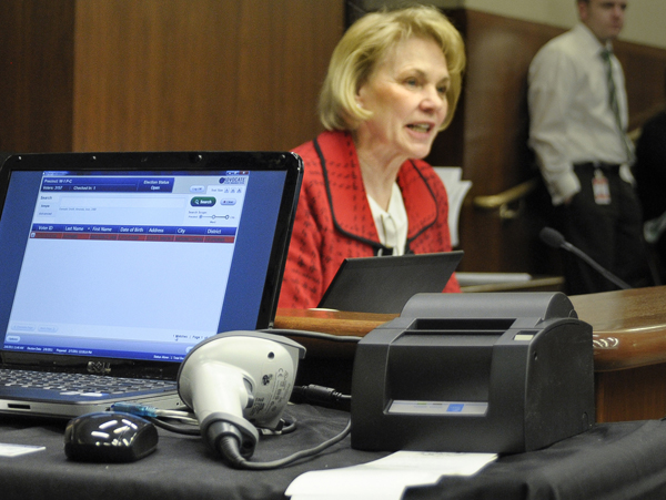 Rep. Mary Kiffmeyer shows members of the House Government Operations and Elections Committee a demonstration of the electronic polling machine and new voter ID during Feb. 8 discussion of a bill that would require voters to show a picture identification before receiving a ballot. (Photo by Andrew VonBank)