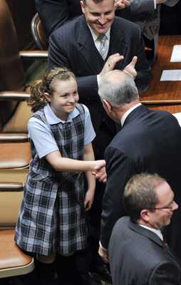 Ten-year-old Alice Lesch, daughter of Rep. John Lesch, gets a warm handshake from Gov. Mark Dayton after the State of the State address Feb 9. (Photo by Andrew VonBank)