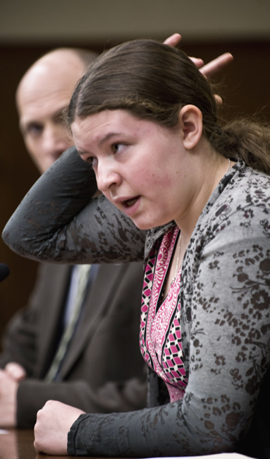 Kayla Meyer of New Prague points to the spot where she struck her head on the ice while playing hockey, as she testifies April 8 before the House Education Reform Committee for a bill that would establish policies for youth athletic activities when a youth athlete suffers a concussion. (Photo by Tom Olmscheid)