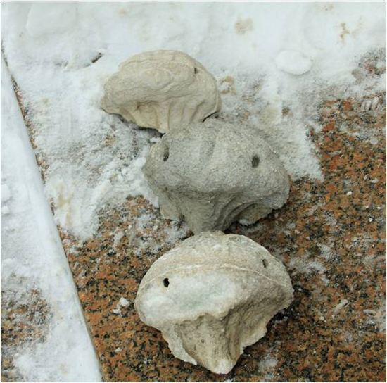 Workers discovered they could break off loose pieces of the building�s marble exterior, like these stone carvings, just by tapping on them with their fingers. (Photo courtesy of the Department of Administration)