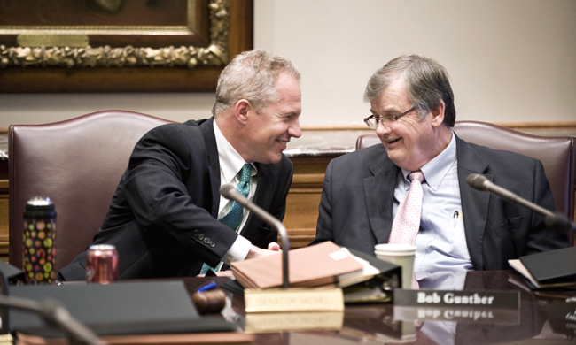 Co-chairs of the omnibus jobs and economic development conference committee, Rep. Bob Gunther,  right and Sen. Geoff Michel shake hands after the committee reached an agreement on their proposed budget bill May 16. (Photo by Tom Olmscheid)