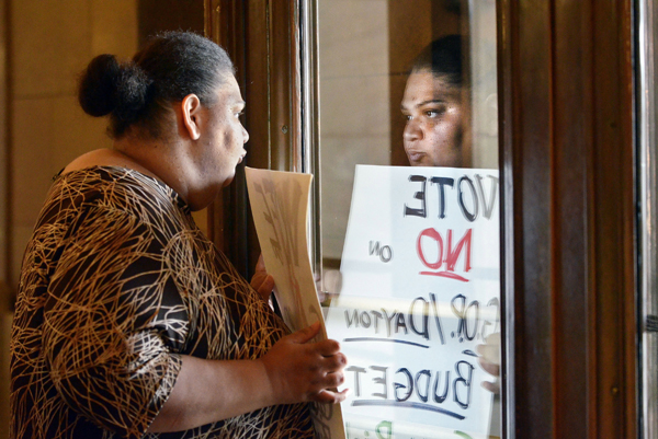 Representing the Welfare Rights Committee, Angel Buechner of Minneapolis waits for legislators after being among the first to enter the Capitol July 19, 2011. Doors to the building had been locked since the state government shutdown began July 1. (Photo by Andrew VonBank)
