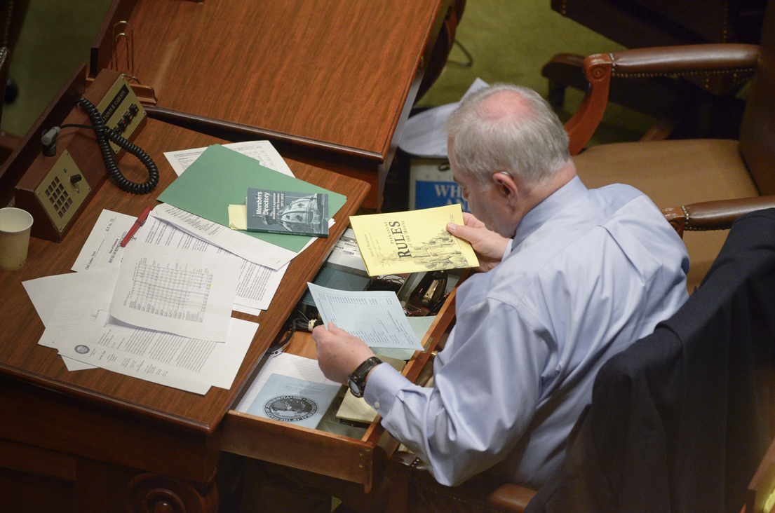 Rep. Lyndon Carlson Sr. cleans out his desk in the early morning hours of May 10, the last day of the 2012 session. Carlson has served in the Legislature for 40 years. (Photo by Andrew VonBank)