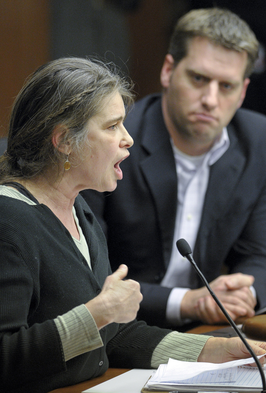 Deb Konechne, representing the Minnesota Coalition for a Peoples Bailout, testifies before the House Health and Human Services Reform Committee Feb. 22 in opposition to a bill that would modify Minnesota Family Investment Program eligibility, sanctions and time limits. The bills sponsor, Rep. Kurt Daudt, listens to the testimony. (Photo by Andrew VonBank)