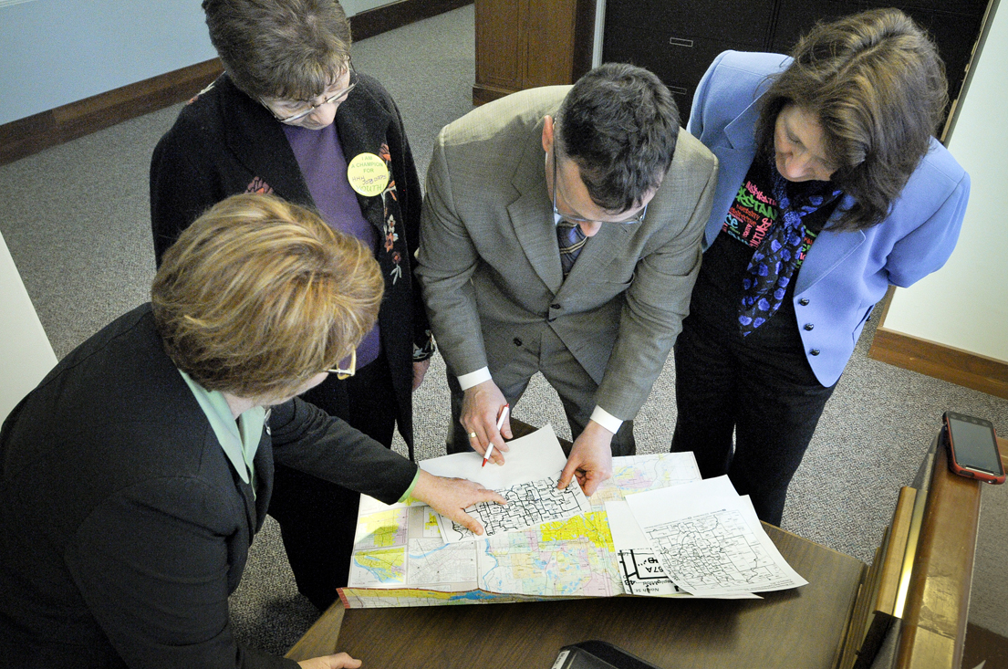 From left: Reps. Erin Murphy, Alice Hausman and John Lesch and Sen. Mary Jo McGuire scrutinize the newly released district maps Feb. 21. (Photo by Andrew VonBank)