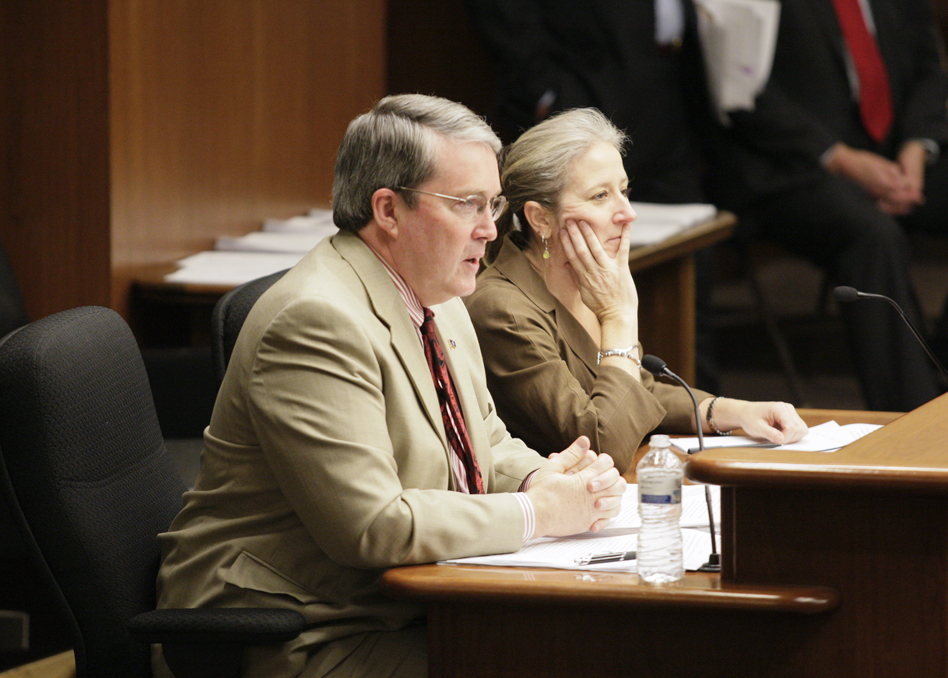 Rep. Michael Beard, left, and lobbyist Lisa Frenette discuss HF2169 with members of the House State Government Finance Committee March 6. The bill would increase legislative scrutiny of administrative rules. (Photo by Paul Battaglia)