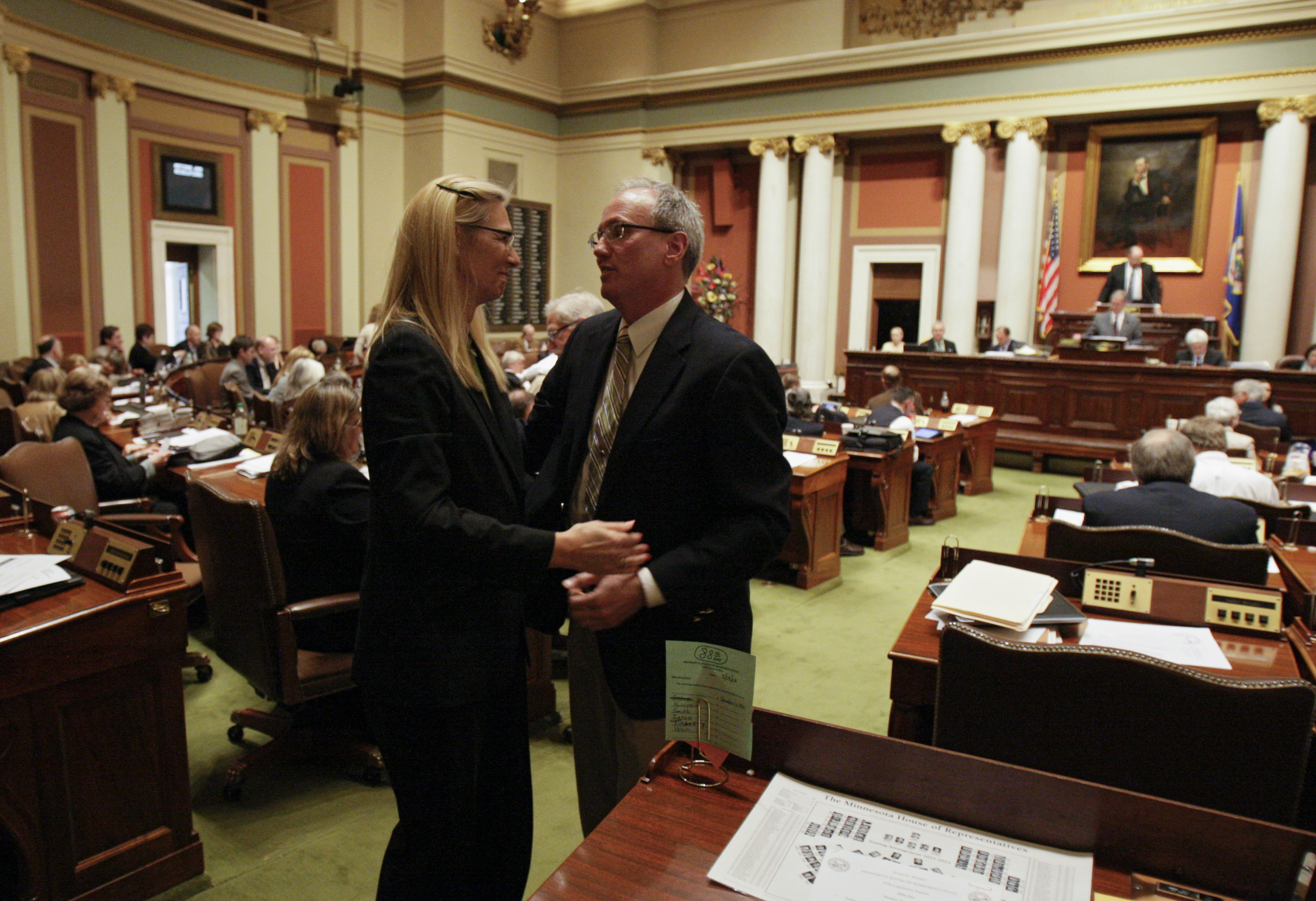 Rep. Denise Dittrich congratulates Rep. Tim O�Driscoll after his bill that would transfer management of the Permanent School Fund lands to five members appointed by the governor was passed by the House March 19. (Photo by Paul Battaglia)